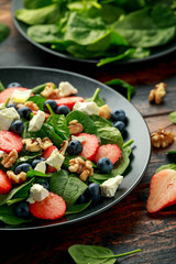 Spinach, Strawberry, blueberry salad with walnut and feta cheese. Summer healthy food