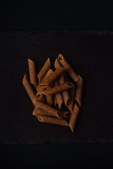 Stock photo of black ceramic with horizontal macaroons . All on black background.