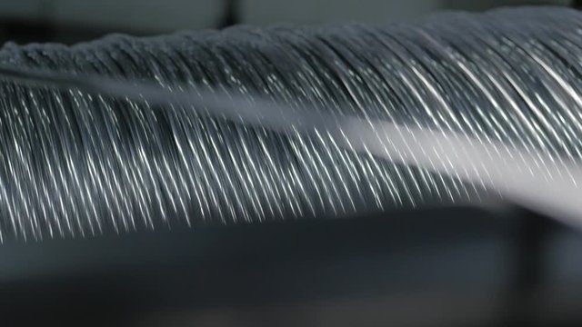 Winding cable on a rotating coil. Production of electric cable.