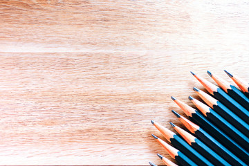 black pencils isolated on wood surface background.Close up.