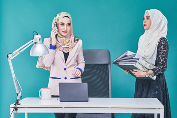 Office Lady with bundle of file on the table and laptop