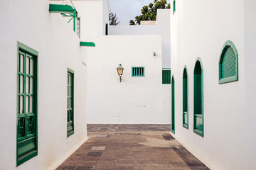 Town with white facades and green windows in Costa Teguise on Lanzarote Island, Canary Islands, Spain