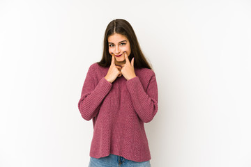 Young caucasian woman isolated on white background doubting between two options.