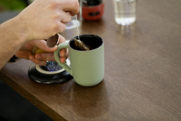 close up of tea infusing cup with honey