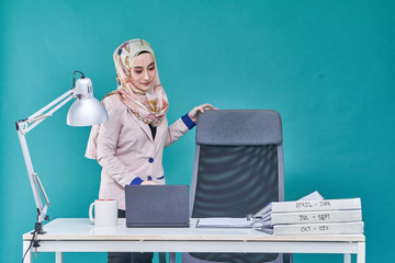 Office Lady with bundle of file on the table and laptop