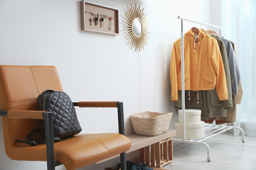 Hallway interior with stylish furniture, clothes and accessories