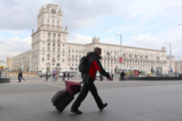 Blurred image of a man with a suitcase. Travel concept.