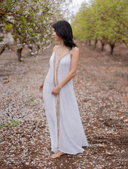 Beautiful romantic slim girl dance in white dress among blossom almond garden. Gardening. Full in bloom. Seasonal greetings. Spring mood and happiness, ecofriendly concept