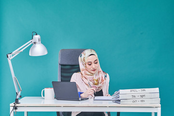 Office Lady with bundle of file on the table and laptop