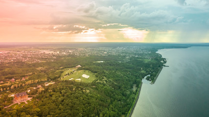spectacular and very colorful sunset over the golf course in the private residence of Mezhyhiria and the small village of New Petrovtsy .Kyiv, Ukraine - Cityscape Aerial Flight