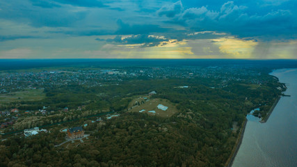 spectacular and very colorful sunset over the golf course in the private residence of Mezhyhiria and the small village of New Petrovtsy .Kyiv, Ukraine - Cityscape Aerial Flight