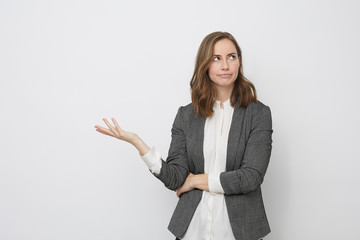 Businesswoman raising her hand not knowing what to do