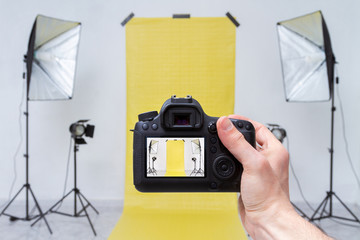 Taking photo in a photo studio with yellow backdrop