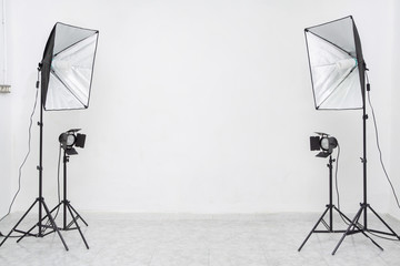 Studio lights flashes with white wall. Copy​ space​ for​ text or​ mock-up