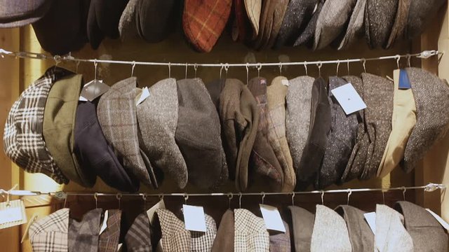 Large assortment of flat caps hanging on showcase in clothes shopcaps, kepi