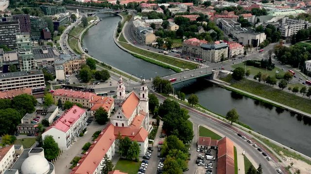 VILNIUS, LITHUANIA - JULY, 2019: Aerial drone view of the church of Archangel Raphael and bridge over the Neris river.