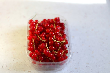 Bowl of red currants on a kitchen counter. Selective focus.