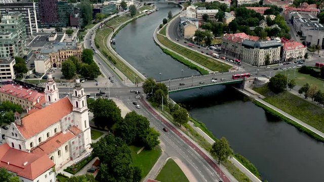 VILNIUS, LITHUANIA - JULY, 2019: Aerial drone view of the church of Archangel Raphael and bridge over the Neris river.