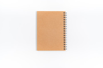 Brown spiral notebook isolated on white background.top view