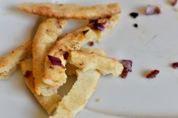 Uneaten pizza  crusts on a plate 