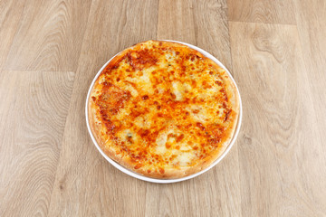 mix cheeses pizza on a wooden background