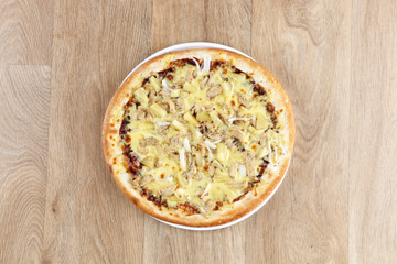 Hawaiian pizza pizza close up - pineapple - on a wooden background  - closeup