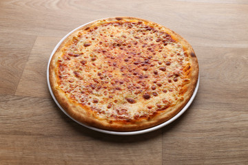 mix cheeses pizza on a wooden background