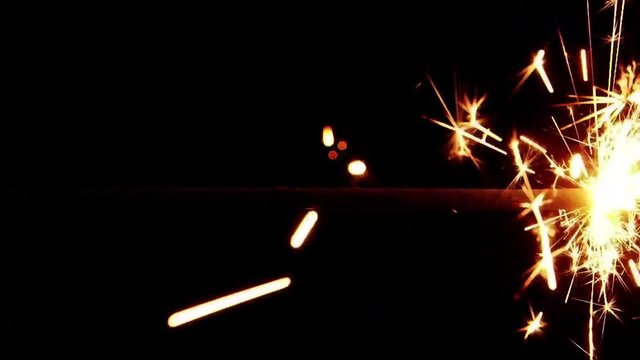 Close up of a burning sparkler on a dark background