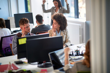 Young business people in office. Colleagues in office. Businesswoman and businessman discussing work in office. Man and woman  working together.