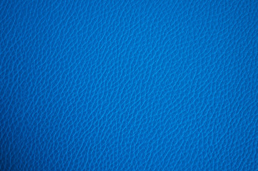 Leather texture close up. Blue fashionable background, top view. Stylish wallpaper of snake skin. Rough surface of navy blue color.