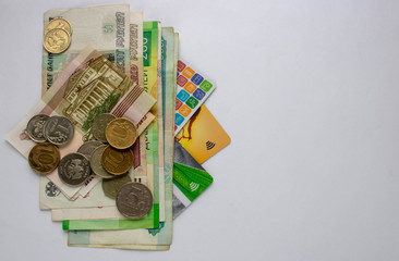 Russian banknotes, coins and Bank cards are on a white background. Close up
