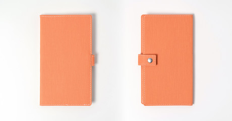 top view blank orange leather diary on white desk
