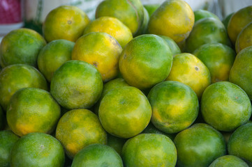 Green fresh whole ripe green tangerine as a texture