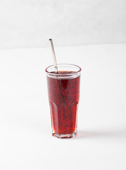 Herbal fruit drink pomegranate with mint in a glass on a light background