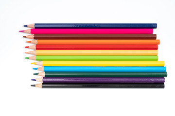 Colored pencils in a row isolated on white background.