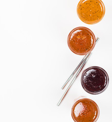 Herbal fruit berry drink in a glass, pineapple with Basil, pomegranate with mint, sea buckthorn with oregano on a light background