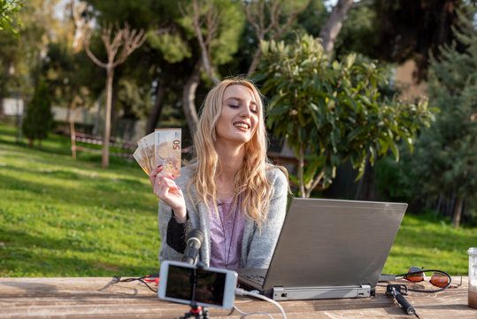 Female blond blogger demonstrates money earned