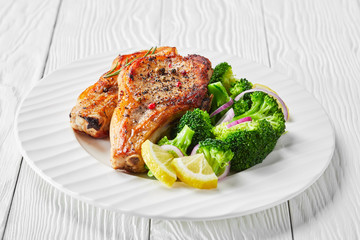 close-up of broiled pork rib chops on a plate