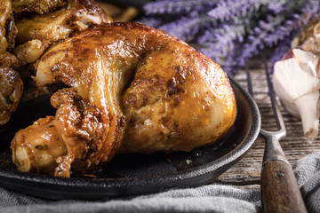 Quarters of fried chicken in a cast iron skillet.