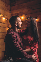 Pregnant girl enjoying her condition with her beloved posing in a photo
