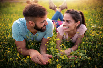 Couple relaxing on grass.