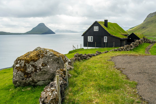 House on edge of Velbasta&eth;ur with view towards island of Koltur on the Faroe Islands