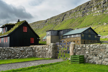 Obraz premium Kirkjubøur (Danish: Kirkebø) is the southernmost village on Streymoy, Faroe Islands. The village is located on the south-west coast of Streymoy and has a view towards the islands Hestur and Koltur