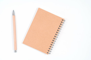 Top view blank Wood color diary and pencil on white desk