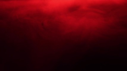 Red smoke spreads like fog. Texture of cigarette white smoke on a black background. Slow motion.