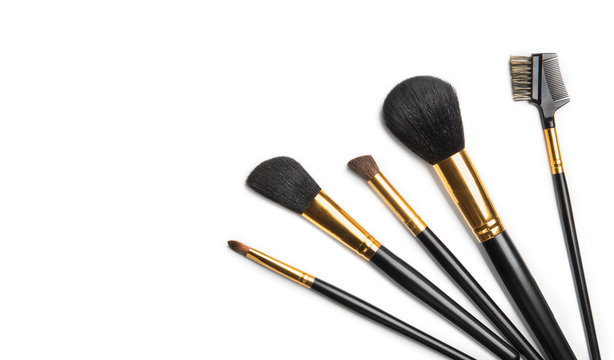 Make-up Brushes set over white background. Various Professional makeup brush on white in studio. Make up artist tools. Flatlay, top view, flat lay border backdrop