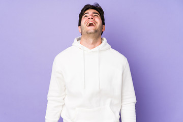 Fototapeta premium Young man isolated on purple background shouting very angry, rage concept, frustrated.