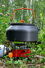 Kettle and portable gas stove in a tourist camp