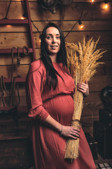 A pregnant girl together with her beloved poses and rejoices in pregnancy. Happy moments