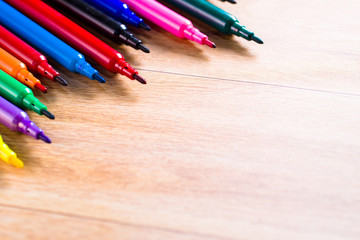Obraz premium multicolored pencils on the wooden table background